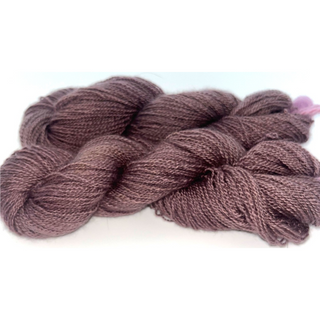 skeins of twisted yarn in a dusty mauve-brown color, photographed on a plain white background.
