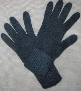 A pair of dark navy blue knit gloves laid flat on a light beige textured fabric background.