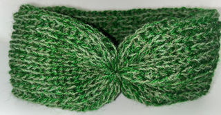 A green knit ear warmer headband with a bow detail at the center, shown on a plain white background.